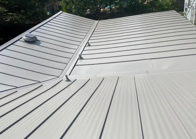 Solar attic fan installed on a metal roof for Roof Ventilation in Guilderland